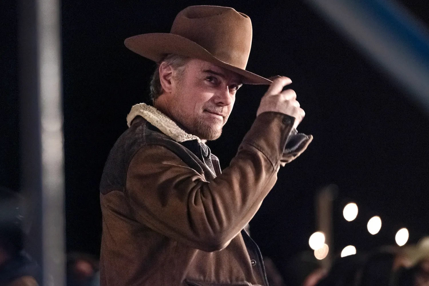 Josh Duhamel as Staten Kirkland tipping his cowboy hat in a night scene from Ransom Canyon
