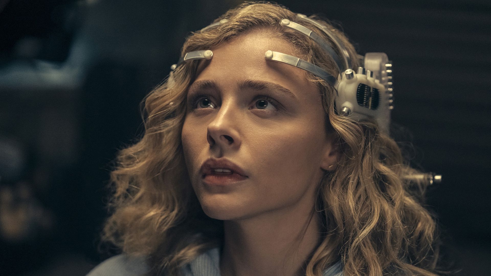 Chloë Grace Moretz wearing a futuristic neural headset in The Peripheral