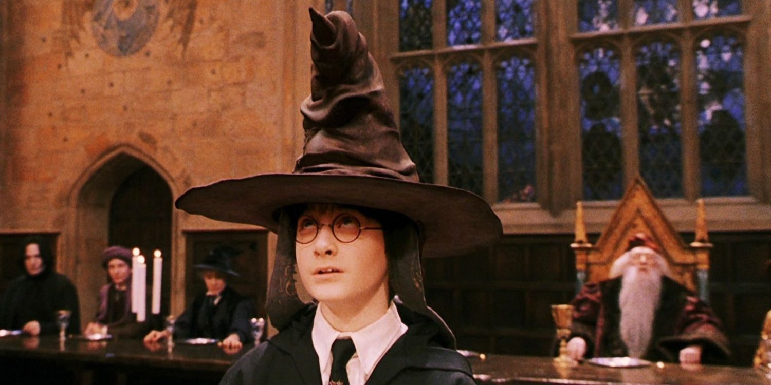 Harry Potter sitting on the stool under the Sorting Hat in the Great Hall